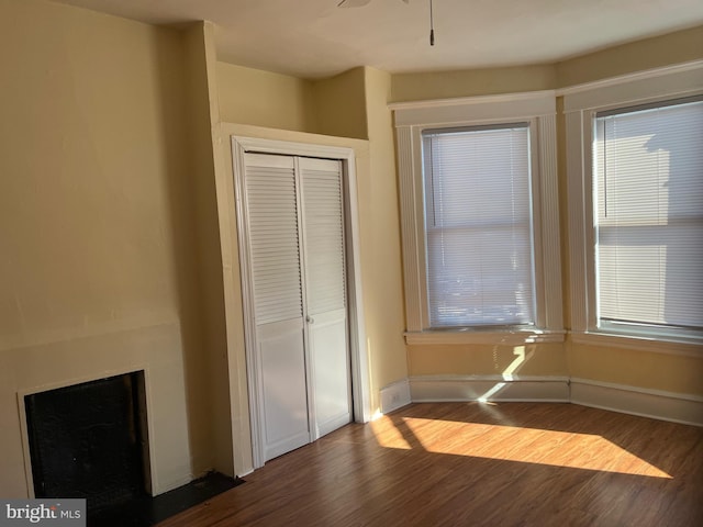 unfurnished bedroom featuring a closet and hardwood / wood-style flooring