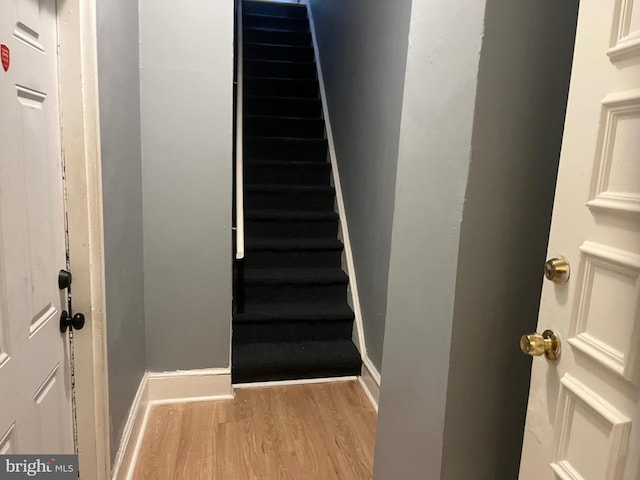 stairway featuring hardwood / wood-style flooring