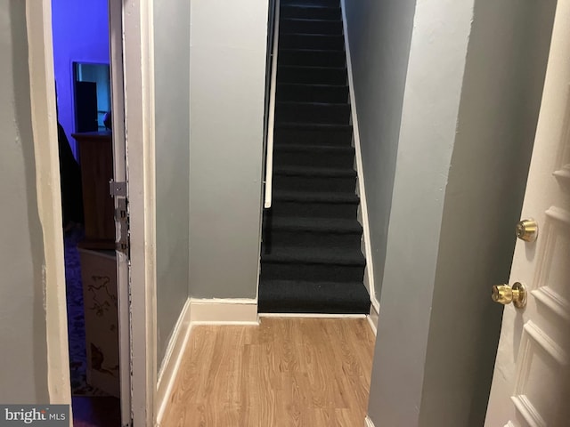 stairs with wood-type flooring