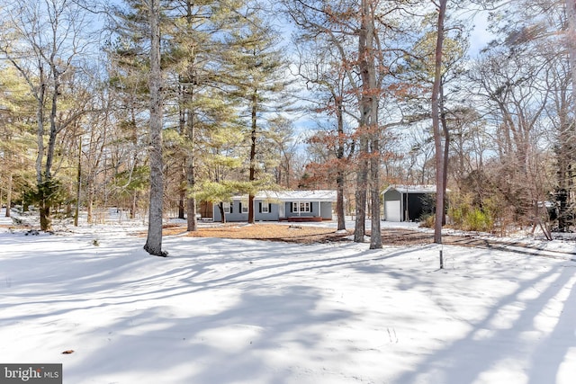 view of front of property featuring a garage and an outdoor structure