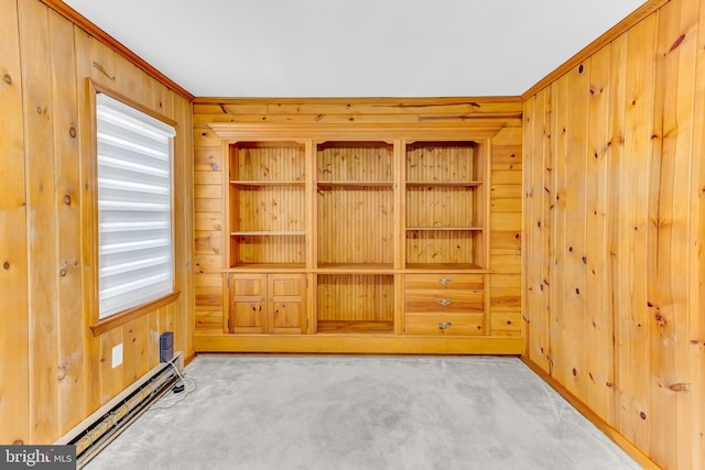 unfurnished room featuring a baseboard heating unit, crown molding, light colored carpet, and wood walls