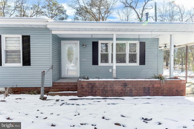 view of snow covered property entrance