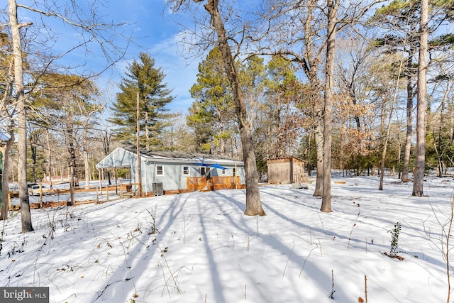 yard covered in snow with a wooden deck