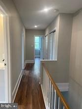 hallway featuring dark hardwood / wood-style flooring