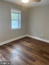 spare room featuring ceiling fan and dark hardwood / wood-style flooring