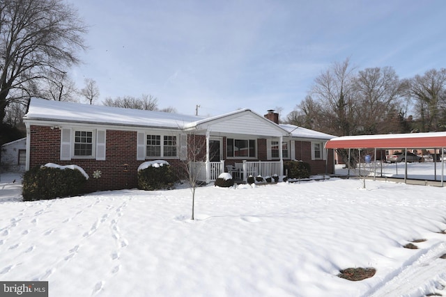 ranch-style home with a carport and covered porch