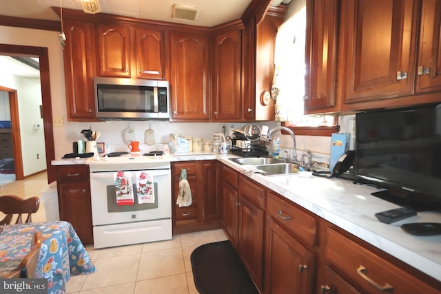 kitchen featuring crown molding, white range with electric stovetop, light tile patterned floors, and sink