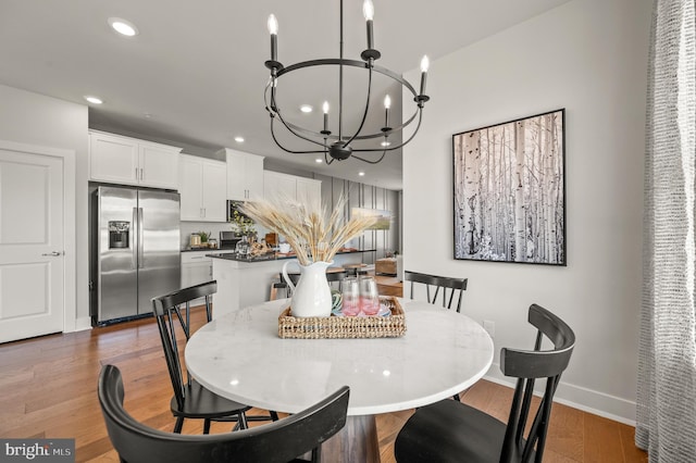 dining room with a notable chandelier and dark hardwood / wood-style floors