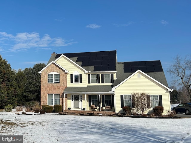 front of property featuring covered porch and solar panels