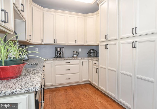 kitchen featuring light stone counters and light hardwood / wood-style floors