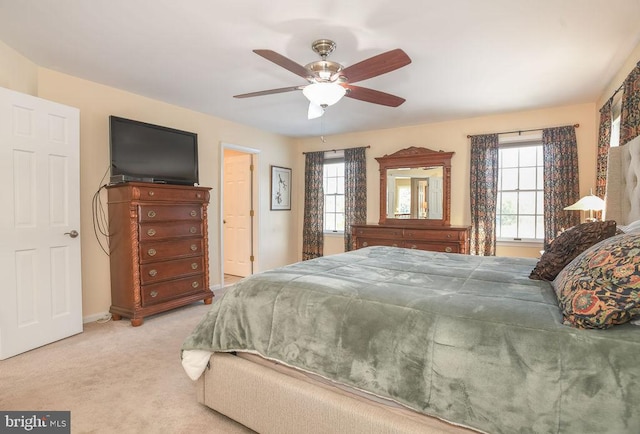 bedroom with light carpet and ceiling fan