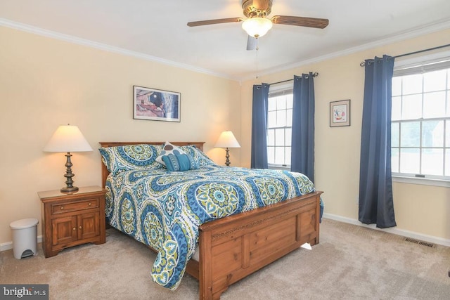 carpeted bedroom with ceiling fan and ornamental molding