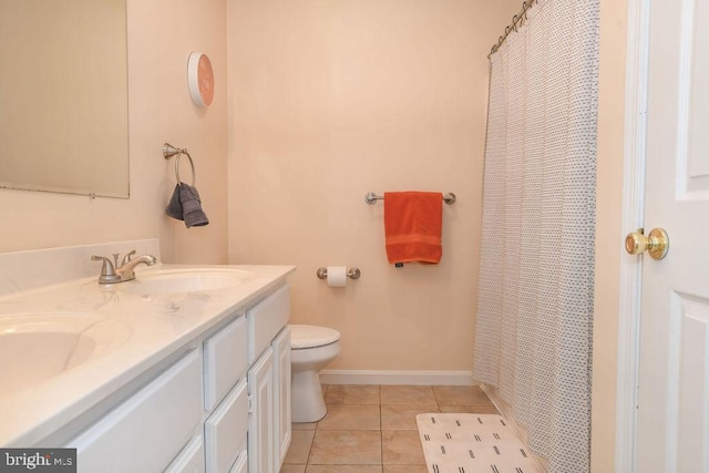 bathroom featuring vanity, toilet, a shower with shower curtain, and tile patterned flooring