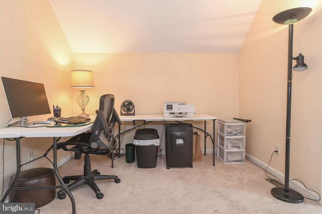 office space featuring light carpet and vaulted ceiling