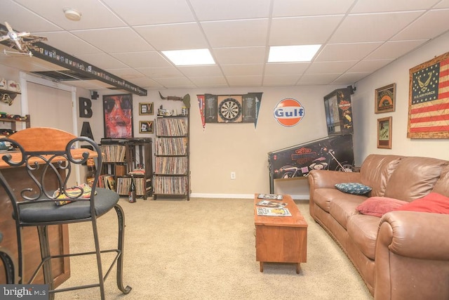 carpeted living room with a paneled ceiling