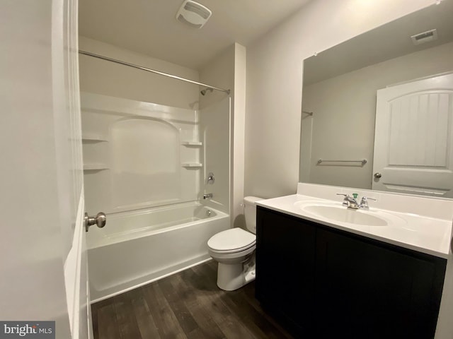 full bathroom featuring hardwood / wood-style floors, vanity, shower / bathtub combination, and toilet