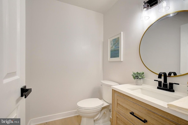 bathroom featuring toilet and vanity