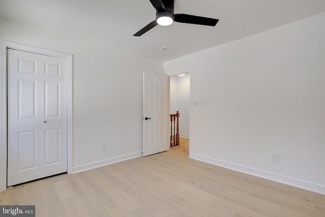 unfurnished bedroom with ceiling fan, a closet, and light hardwood / wood-style floors