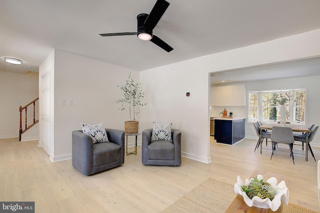 sitting room featuring ceiling fan and light wood-type flooring