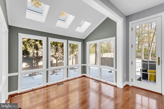 unfurnished sunroom featuring vaulted ceiling