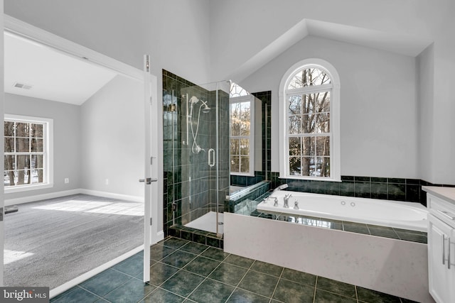 bathroom with tile patterned floors, vanity, lofted ceiling, and plus walk in shower