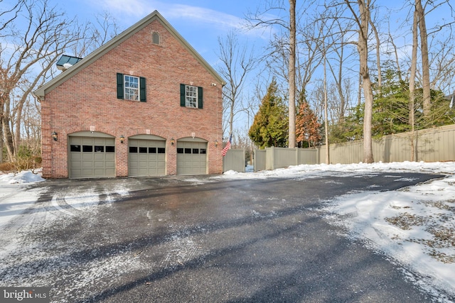 snow covered property featuring a garage