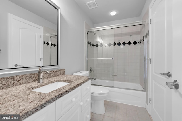 full bathroom featuring toilet, combined bath / shower with glass door, tile patterned flooring, and vanity