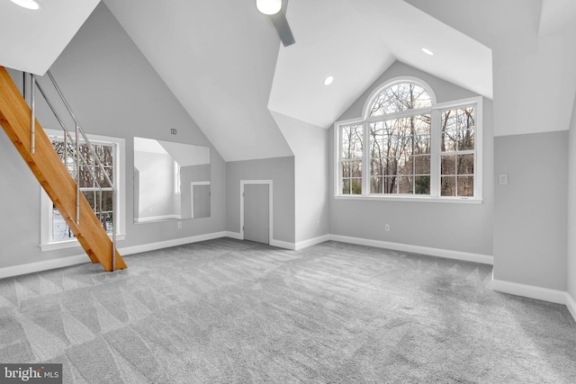 unfurnished living room featuring light colored carpet and lofted ceiling