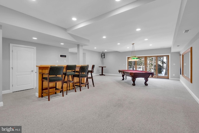 playroom featuring light carpet, pool table, and bar area