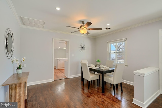 dining space featuring dark hardwood / wood-style flooring, ceiling fan, and ornamental molding