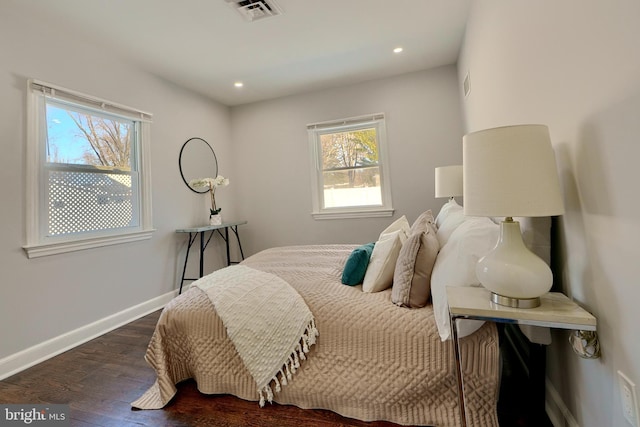 bedroom with dark hardwood / wood-style floors