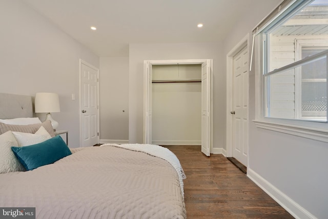 bedroom with dark hardwood / wood-style floors