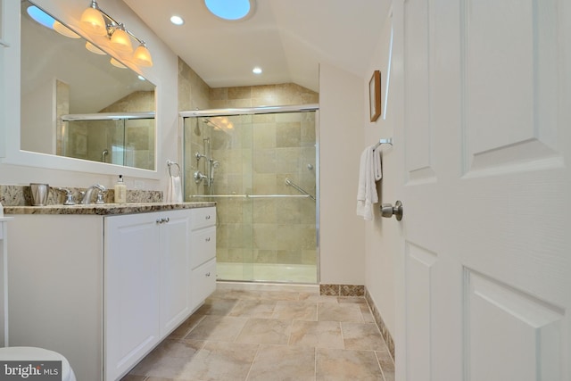 bathroom featuring walk in shower and vanity