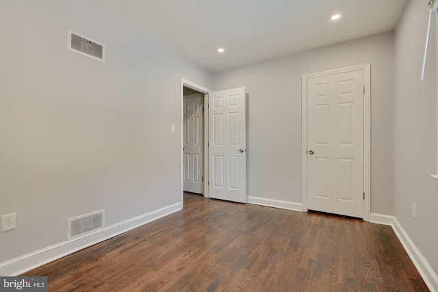 unfurnished bedroom featuring dark hardwood / wood-style floors