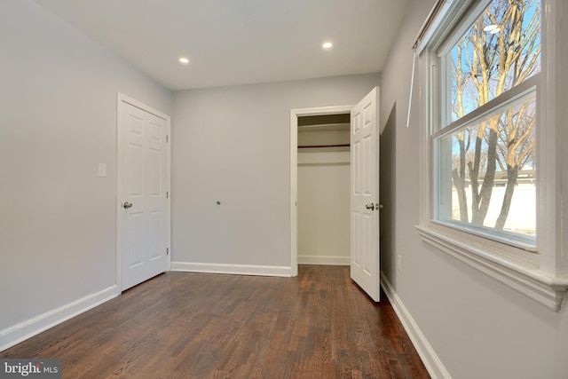 unfurnished bedroom featuring dark hardwood / wood-style floors