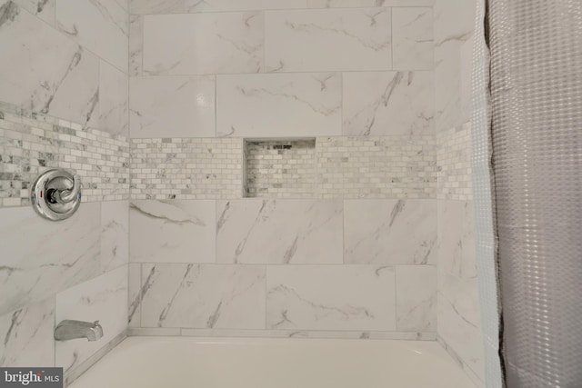 interior details featuring shower / tub combo