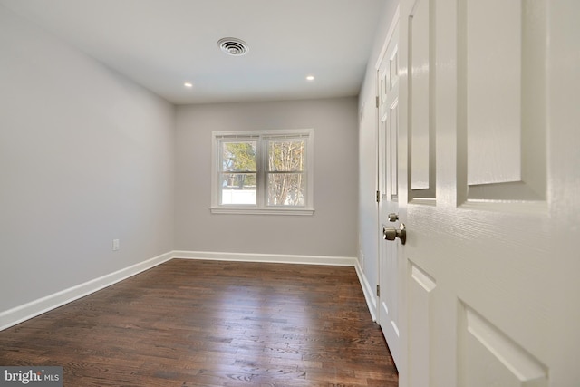 unfurnished room featuring dark hardwood / wood-style floors