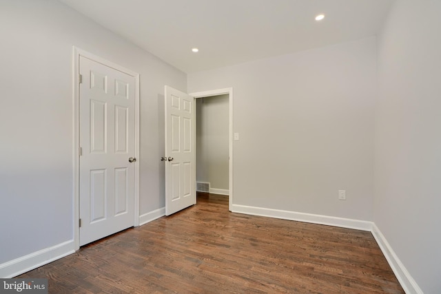 unfurnished bedroom featuring dark hardwood / wood-style flooring