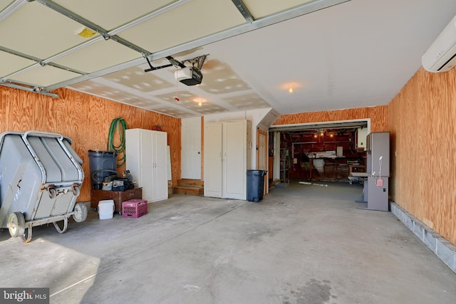 garage with a garage door opener, a wall mounted AC, and wooden walls