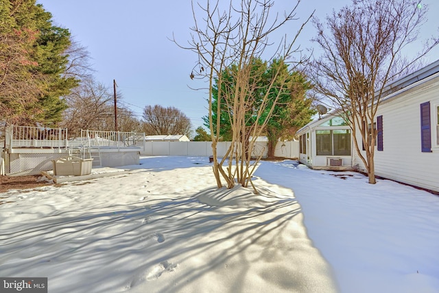 snowy yard featuring a deck