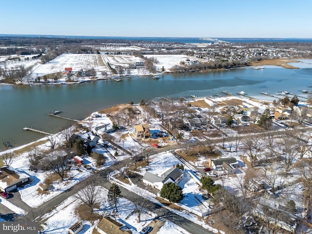 snowy aerial view featuring a water view