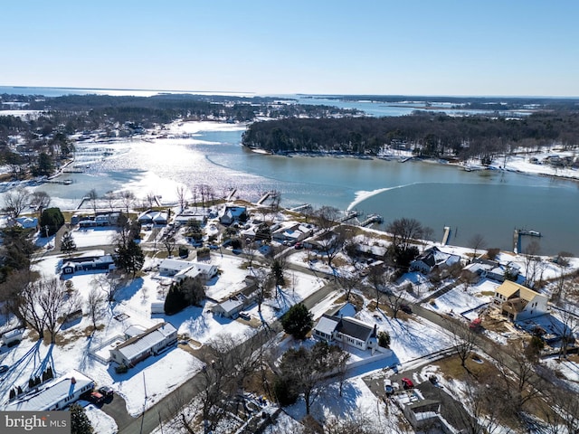 snowy aerial view with a water view