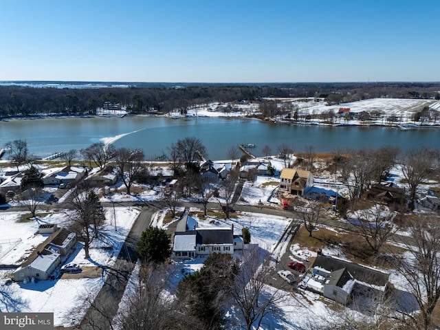 snowy aerial view featuring a water view