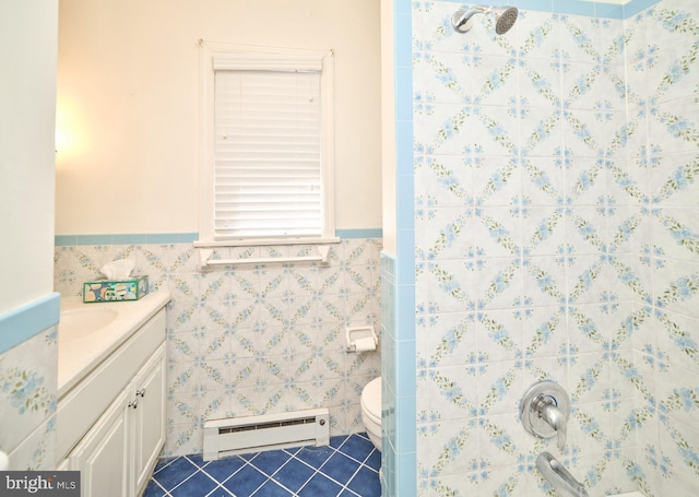 bathroom featuring tile patterned flooring, vanity, tile walls, and a baseboard radiator