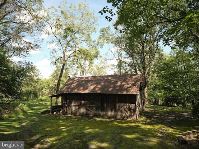 view of outdoor structure featuring a lawn