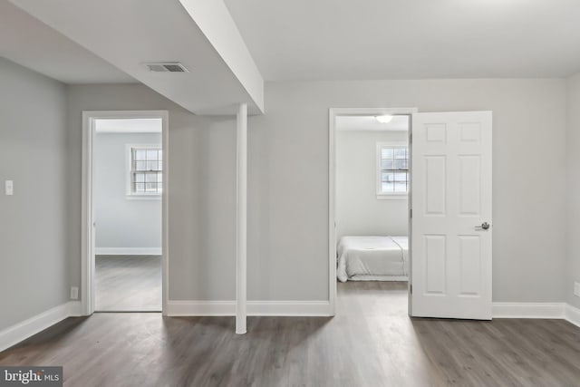 unfurnished bedroom featuring dark hardwood / wood-style floors