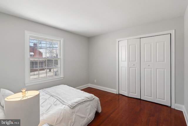 bedroom featuring a closet and dark hardwood / wood-style flooring