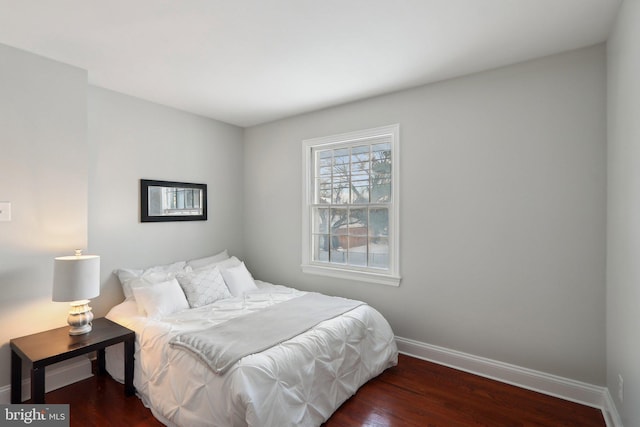 bedroom with dark wood-type flooring