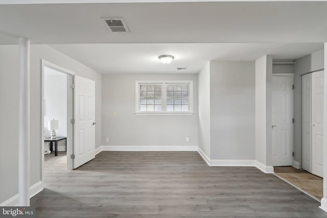 unfurnished room with hardwood / wood-style flooring