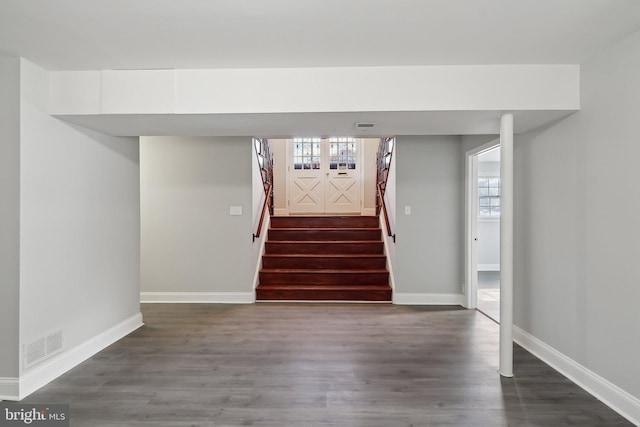 staircase featuring a wealth of natural light and hardwood / wood-style flooring